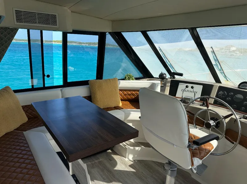 Slide: The Image of 1995 Bayliner 4788 Pilothouse Motoryacht interior with seating, table, and steering wheel. - 10