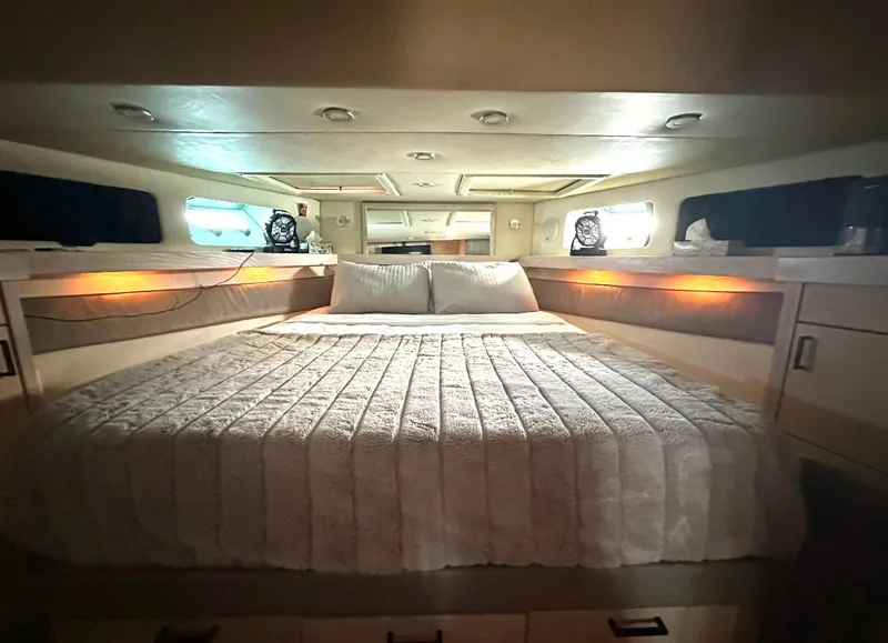 Slide: The Image of Luxurious bedroom interior of 1995 Bayliner 4788 Pilothouse Motoryacht with cozy bedding. - 11