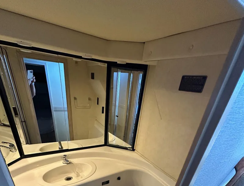 Slide: The Image of Bathroom interior of 1995 Bayliner 4788 Pilothouse Motoryacht with mirrored cabinets. - 12