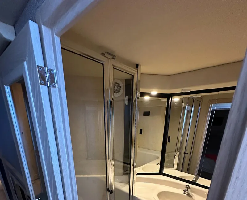 Slide: The Image of Bathroom interior of 1995 Bayliner 4788 Pilothouse Motoryacht with mirrored cabinets. - 13