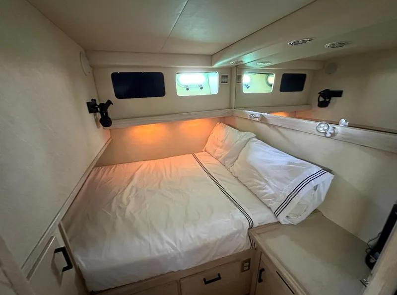 Slide: The Image of Cozy bedroom in 1995 Bayliner 4788 Pilothouse Motoryacht with soft lighting and comfortable bedding. - 17