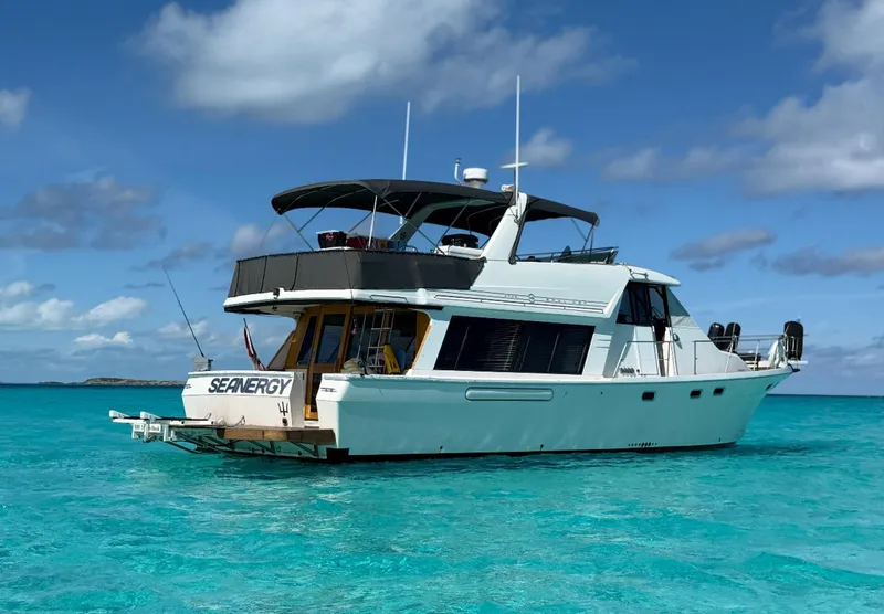 Slide: The Image of 1995 Bayliner 4788 Pilothouse Motoryacht on turquoise water under blue sky. - 2
