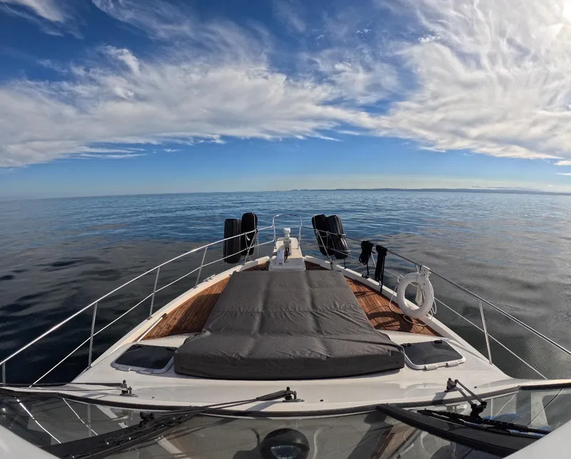 Slide: The Image of 1995 Bayliner 4788 Pilothouse Motoryacht on calm sea under blue sky. - 21