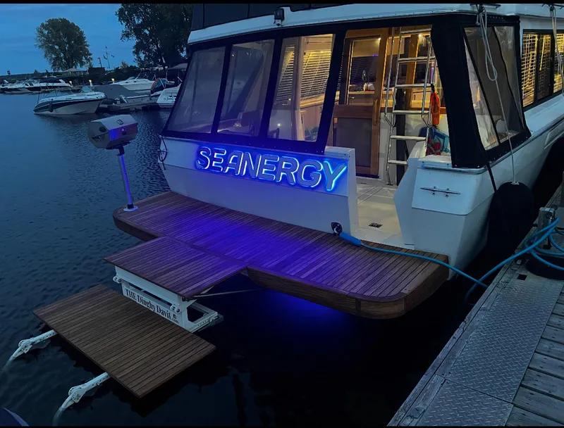 Slide: The Image of 1995 Bayliner 4788 Pilothouse Motoryacht docked with illuminated "SEANERGY" sign. - 26