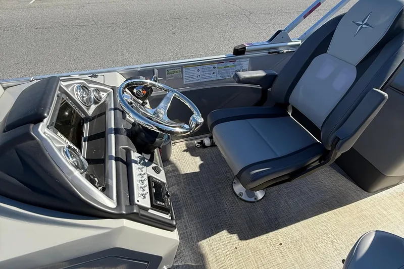 Slide: The Image of 2024 Berkshire 23E STS 3.0 boat cockpit with steering wheel and captain's chair. - 14