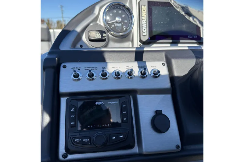 Slide: The Image of Control panel of 2024 Berkshire 23E STS 3.0 boat with switches and display. - 15