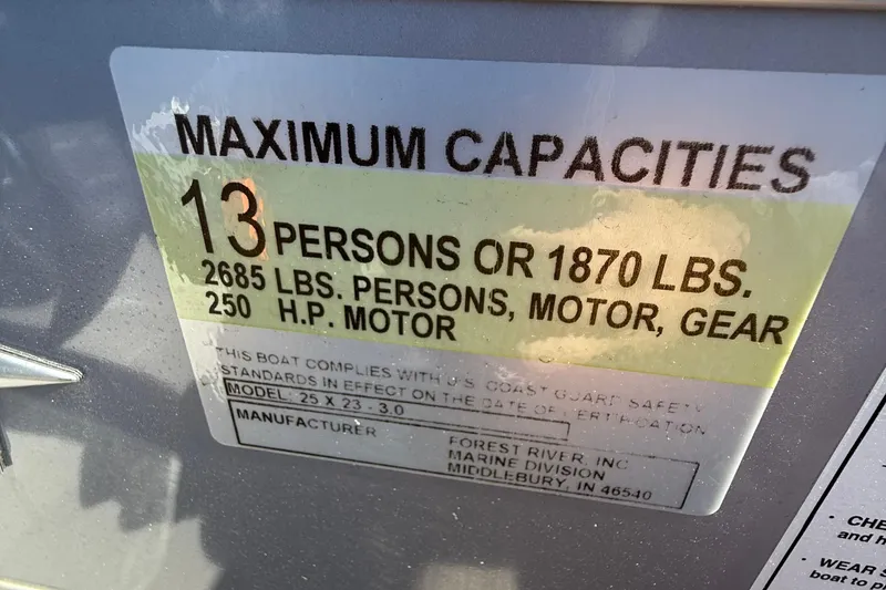 Slide: The Image of 2024 Berkshire 23E STS 3.0 boat capacity label, 13 persons or 1870 lbs, 250 HP motor. - 18