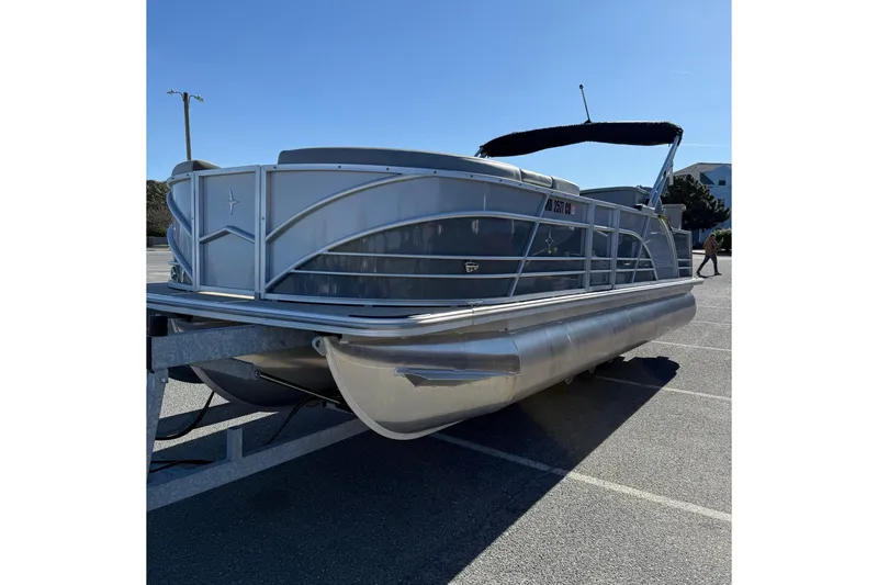 Slide: The Image of 2024 Berkshire 23E STS 3.0 pontoon boat on trailer in parking lot. - 4