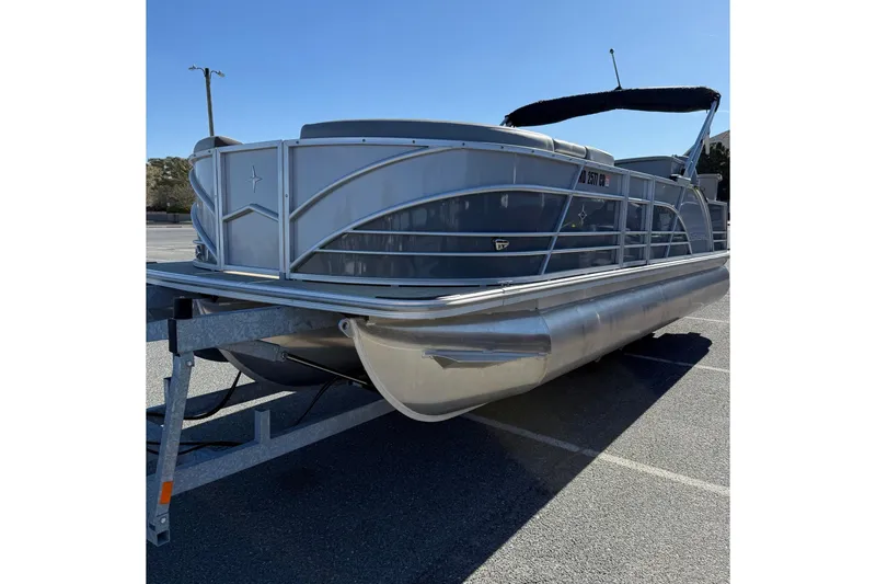 Slide: The Image of 2024 Berkshire 23E STS 3.0 pontoon boat on trailer in parking lot. - 5