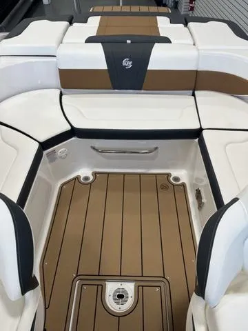Slide: The Image of 2025 Chaparral 23 Surf boat interior with sleek seating and teak-style flooring. - 6
