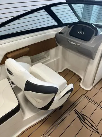 Slide: The Image of 2025 Chaparral 23 Surf boat interior with modern dashboard and comfortable seating. - 7