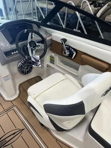 Slide: The Image of 2025 Chaparral 23 Surf boat interior with modern steering and seating. - 8