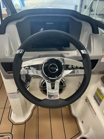 Slide: The Image of 2025 Chaparral 23 Surf boat steering wheel and dashboard, featuring modern controls and design. - 9