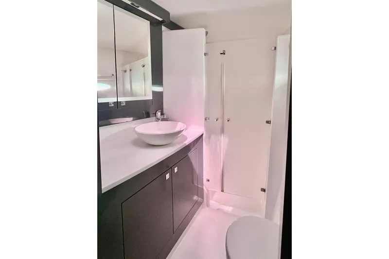 Slide: The Image of Bathroom interior of 2015 Fountaine Pajot Helia Maestro catamaran, featuring modern sink and cabinetry. - 15