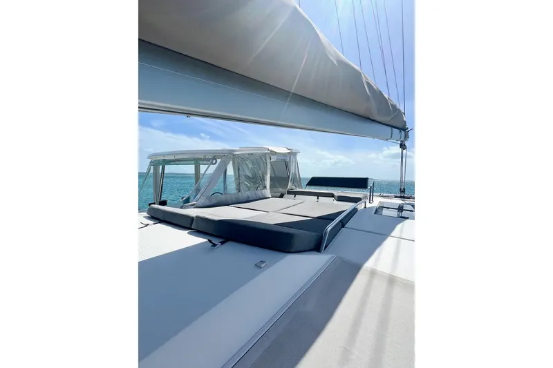 Slide: The Image of 2015 Fountaine Pajot Helia Maestro catamaran deck with sunbathing area and ocean view. - 16