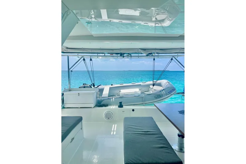 Slide: The Image of 2015 Fountaine Pajot Helia Maestro catamaran interior with ocean view and dinghy. - 4