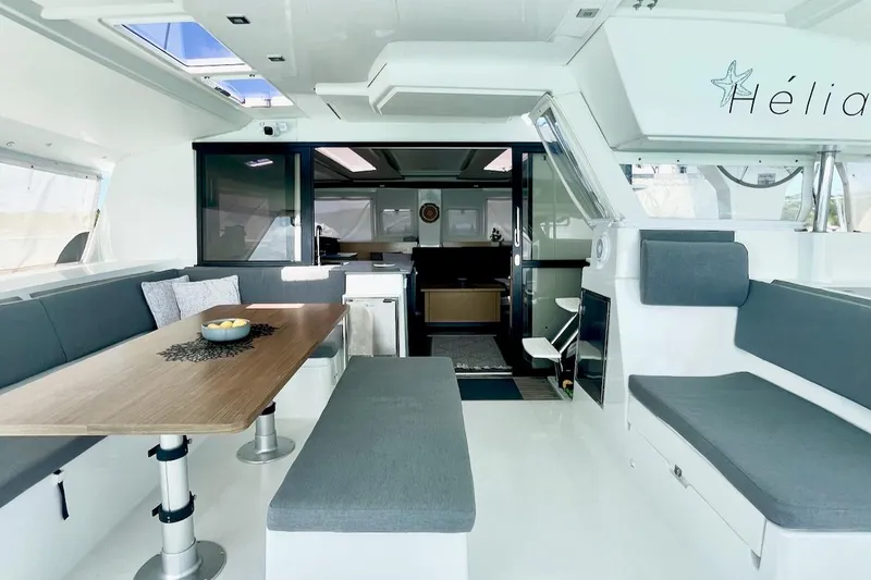 Slide: The Image of Luxurious interior of 2015 Fountaine Pajot Helia Maestro catamaran with modern seating and dining area. - 6