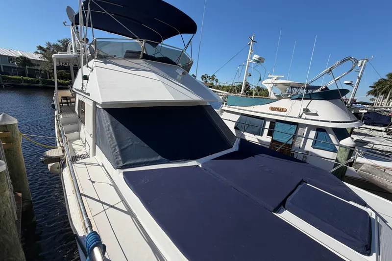 The Image of 1987 Hi-Star 55 Yacht Fisherman docked at marina under clear blue sky. - 0