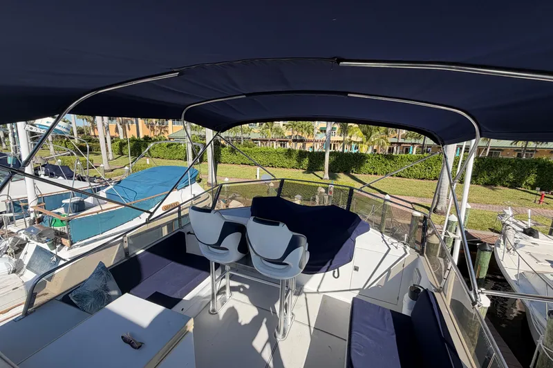 Slide: The Image of 1987 Hi-Star 55 Yacht Fisherman with covered seating area and helm, docked at marina. - 10