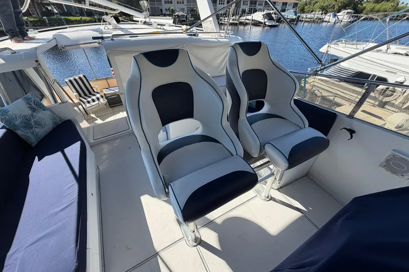 Slide: The Image of Luxury seating on 1987 Hi-Star 55 Yacht Fisherman, docked with scenic marina view. - 11