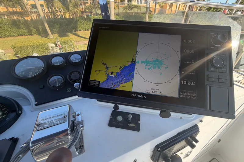 Slide: The Image of 1987 Hi-Star 55 Yacht Fisherman dashboard with Garmin navigation system and engine controls. - 13