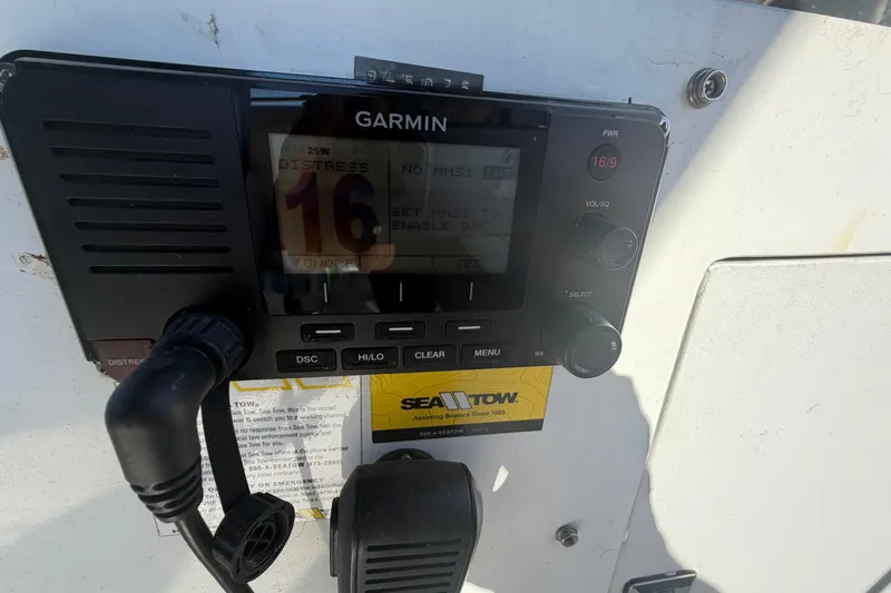 Slide: The Image of Garmin marine radio on 1987 Hi-Star 55 Yacht Fisherman, featuring distress channel 16. - 14