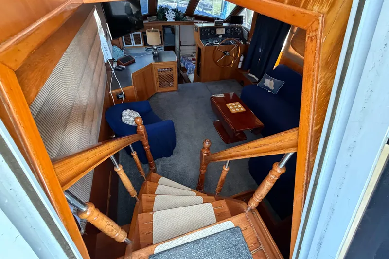 Slide: The Image of Interior of 1987 Hi-Star 55 Yacht Fisherman with wooden stairs and cozy seating area. - 25