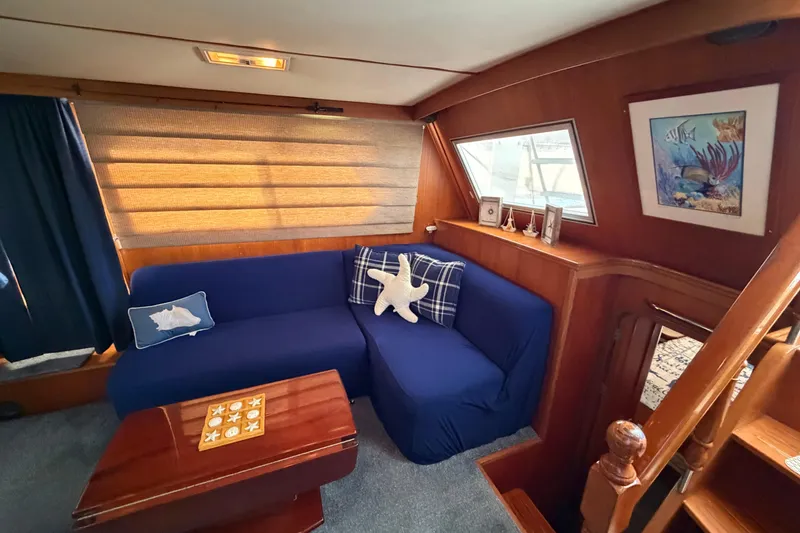 Slide: The Image of Cozy interior of 1987 Hi-Star 55 Yacht Fisherman with blue seating and nautical decor. - 26