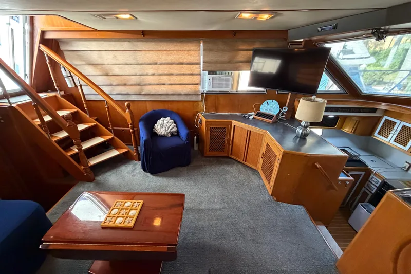 Slide: The Image of 1987 Hi-Star 55 Yacht Fisherman interior with wooden accents, cozy seating, and modern amenities. - 28