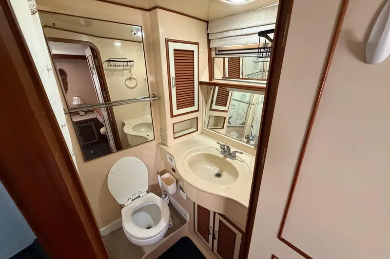 Slide: The Image of 1987 Hi-Star 55 Yacht Fisherman bathroom with sink, toilet, and mirror. - 39