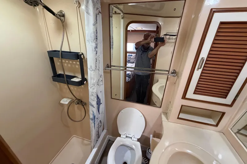 Slide: The Image of 1987 Hi-Star 55 Yacht Fisherman bathroom with shower, toilet, and mirror. - 40