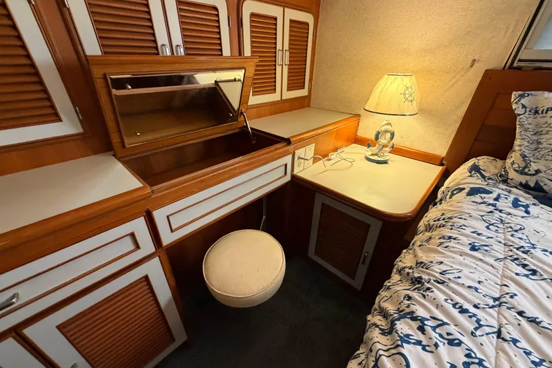 Slide: The Image of 1987 Hi-Star 55 Yacht Fisherman cabin with wooden cabinetry, lamp, and cozy bedding. - 43