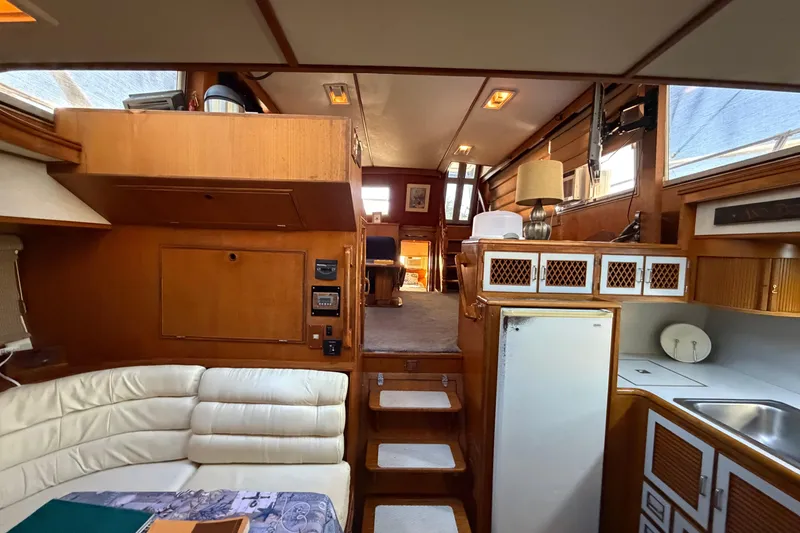 Slide: The Image of Interior of 1987 Hi-Star 55 Yacht Fisherman with wood paneling and cozy seating area. - 49