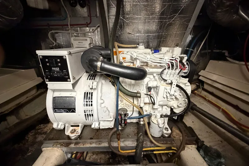 Slide: The Image of Engine room of a 1987 Hi-Star 55 Yacht Fisherman, featuring a generator system. - 57