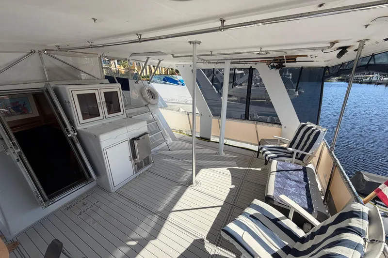 Slide: The Image of 1987 Hi-Star 55 Yacht Fisherman deck with seating, cabinets, and water view. - 7