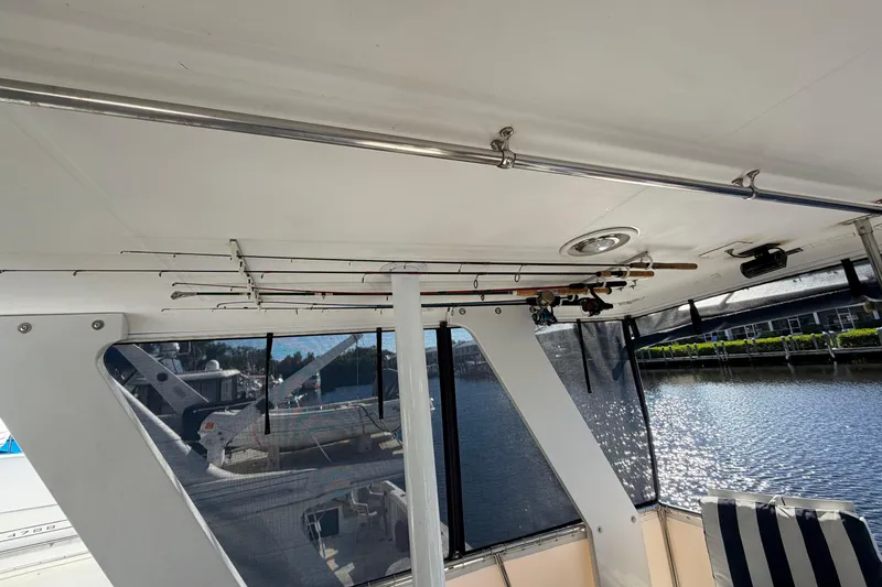 Slide: The Image of 1987 Hi-Star 55 Yacht Fisherman interior with fishing rods stored overhead. - 9
