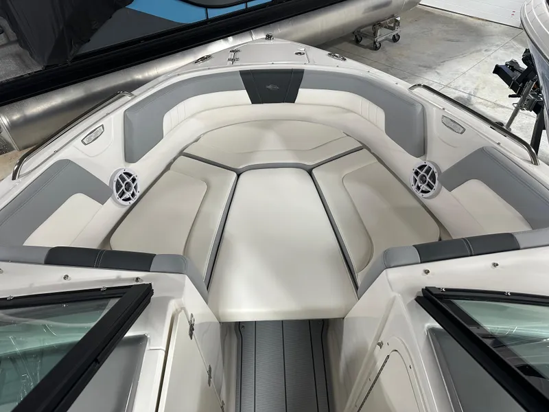 Slide: The Image of 2025 Chaparral 23 SSi boat interior with cushioned seating and speakers. - 10