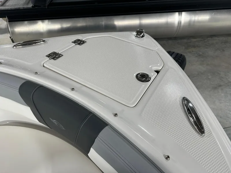Slide: The Image of 2025 Chaparral 23 SSi boat bow with storage hatch and sleek design. - 11