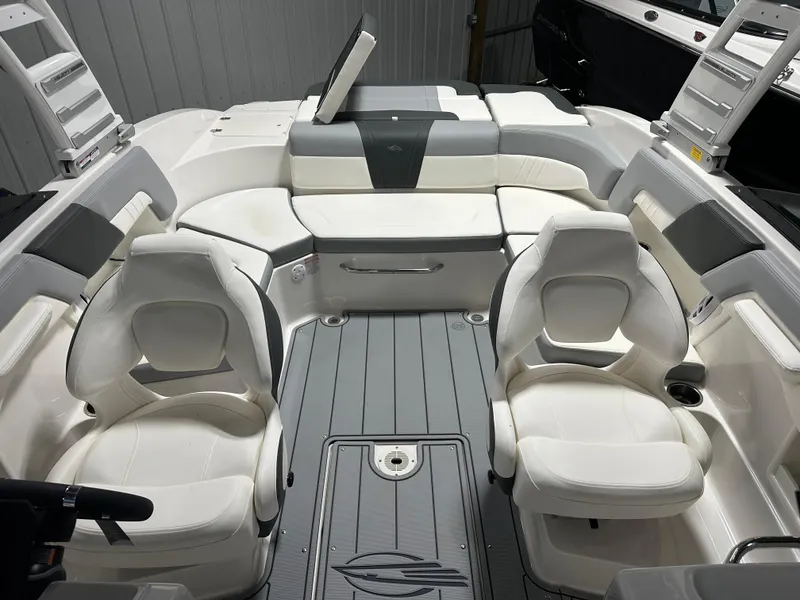 Slide: The Image of 2025 Chaparral 23 SSi boat interior with white seating and sleek design. - 15