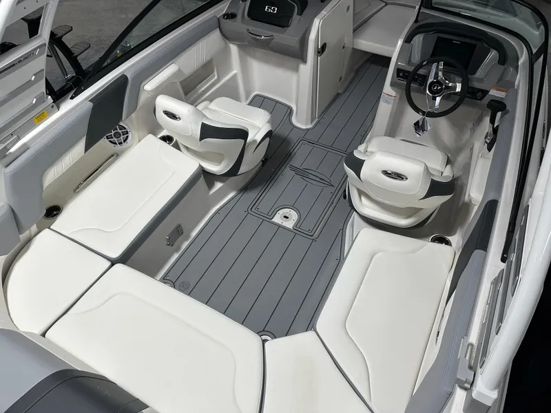 Slide: The Image of 2025 Chaparral 23 SSi boat interior with white seating and modern dashboard. - 9