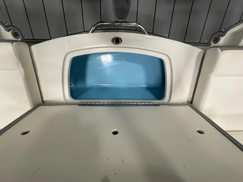 Slide: The Image of 2025 Chaparral 21 SSi boat interior storage compartment with blue lining. - 12