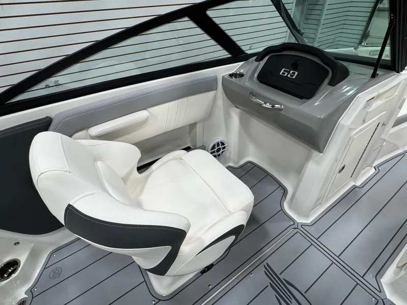 Slide: The Image of 2025 Chaparral 21 SSi boat interior with white seating and modern dashboard. - 14