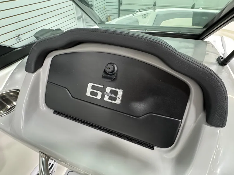 Slide: The Image of 2025 Chaparral 21 SSi boat dashboard with storage compartment and sleek design. - 19