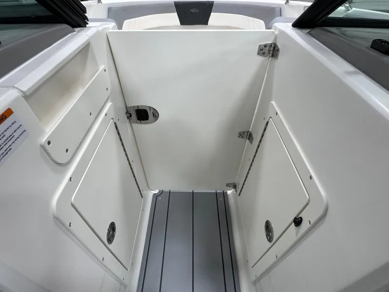Slide: The Image of 2025 Chaparral 21 SSi boat interior with storage compartments and sleek design. - 21