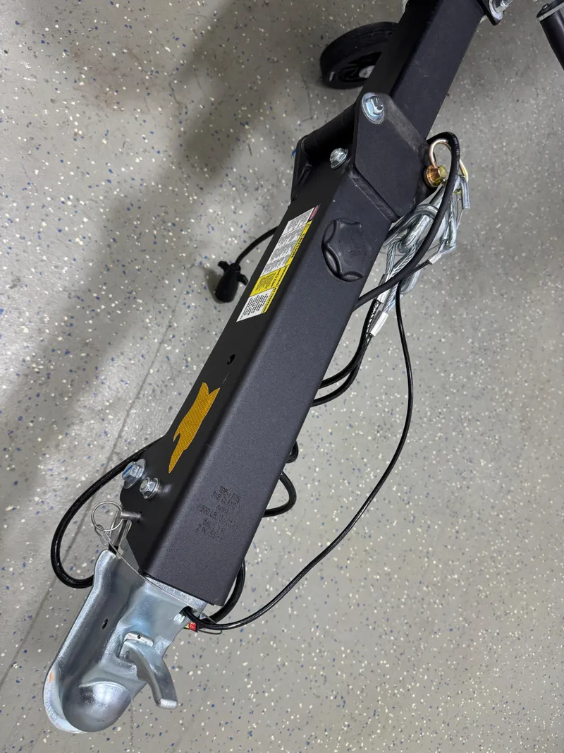 Slide: The Image of Trailer hitch of a 2025 Chaparral 21 SSi boat on a speckled floor. - 23