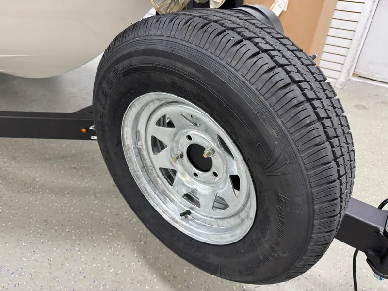 Slide: The Image of Trailer tire for 2025 Chaparral 21 SSi boat on a metal rim. - 24