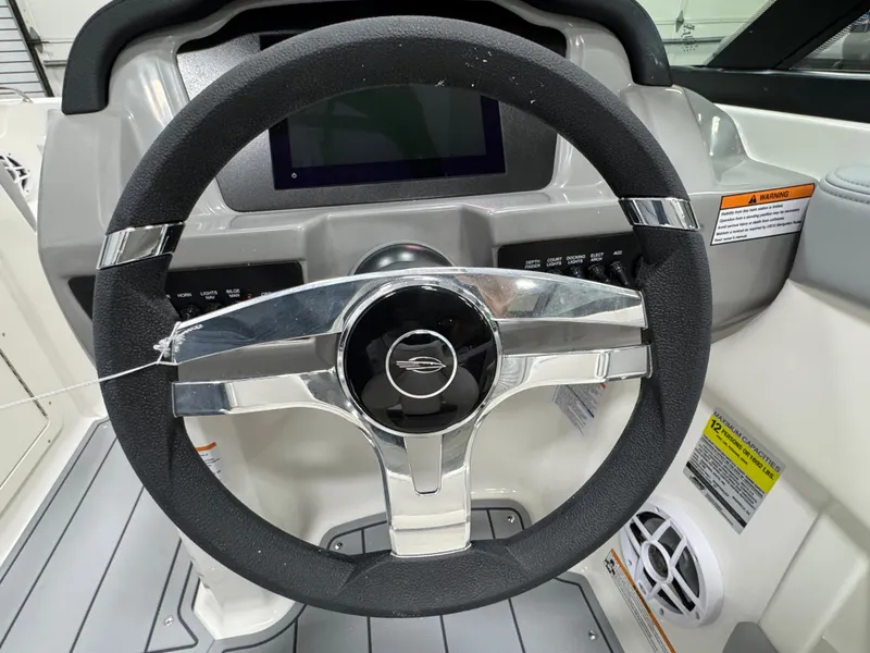 Slide: The Image of Steering wheel of 2025 Chaparral 21 SSi boat with modern dashboard design. - 6