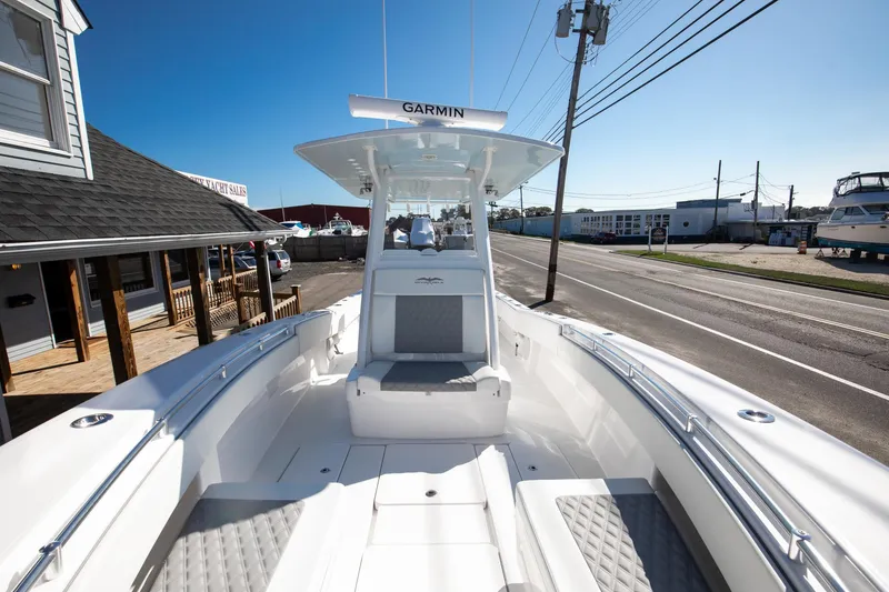 Slide: The Image of 2023 Invincible 33 Open Fisherman boat docked near a marina. - 3