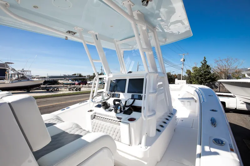 Slide: The Image of 2023 Invincible 33 Open Fisherman boat cockpit with dual screens and seating. - 4