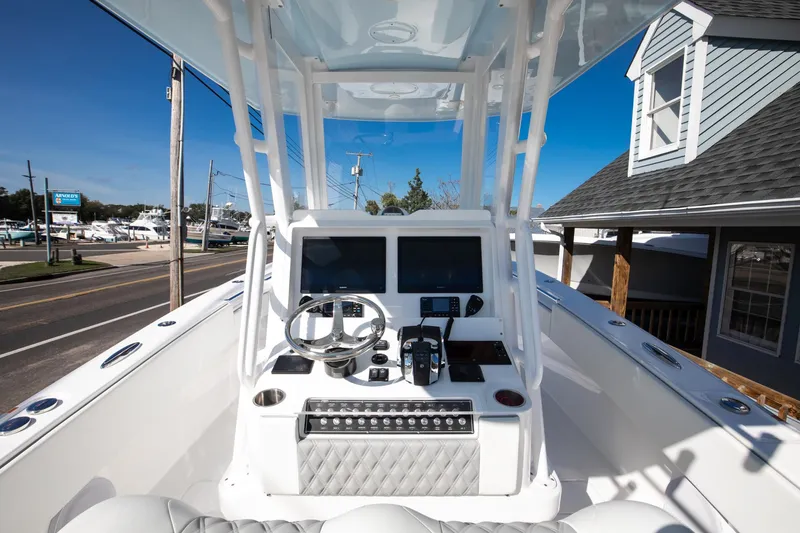 Slide: The Image of 2023 Invincible 33 Open Fisherman boat console with dual screens and steering wheel. - 5